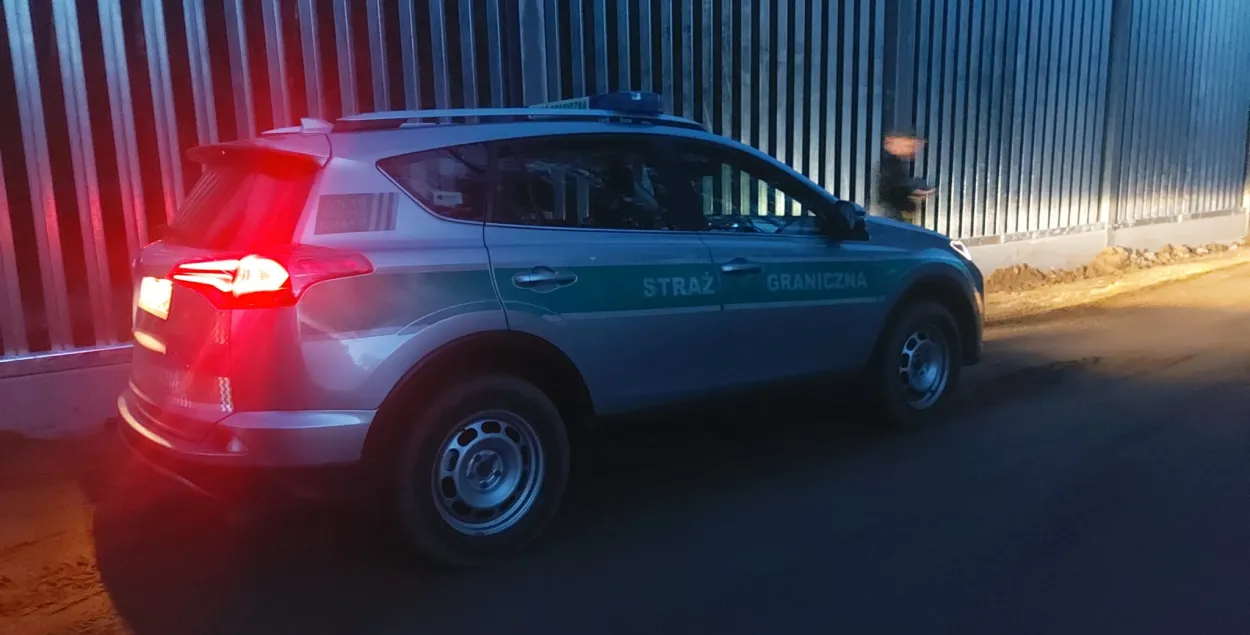 Автомобиль польской погранслужбы на фоне забора на границе с Беларусью
