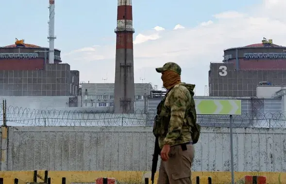 Расійскі ваенны на фоне другога і трэцяга энергаблокаў АЭС / Reuters
